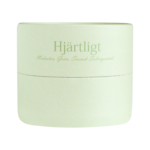 A round, pale green box with text in Swedish, mentioning heart, med scent, and herbs.