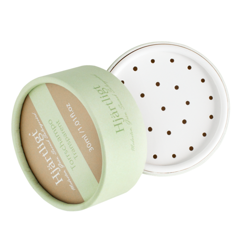 This is a round, light green container with a lid. The lid shows small holes and the container holds natural face powder.