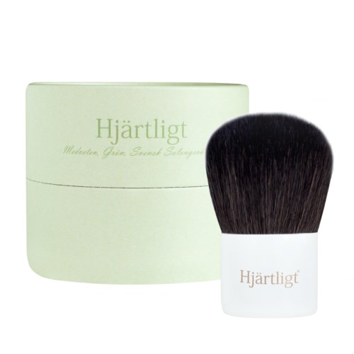 A light green container and a brush with black bristles, labeled 'Hjärtligt' in Swedish.