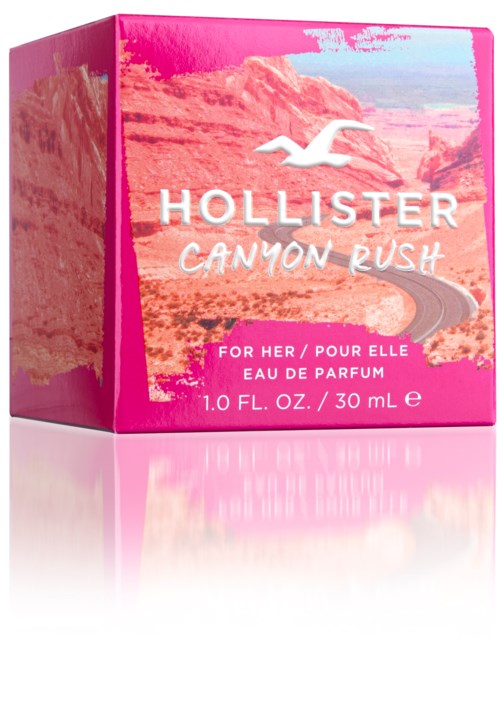 Een roze doos met Hollister Canyon Rush parfum voor vrouwen met woestijnlandschap en meeuwlogo.