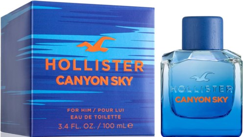 Een blauw doos en fles van Hollister Canyon Sky herengeur, met vogellogo en oranje tekst.