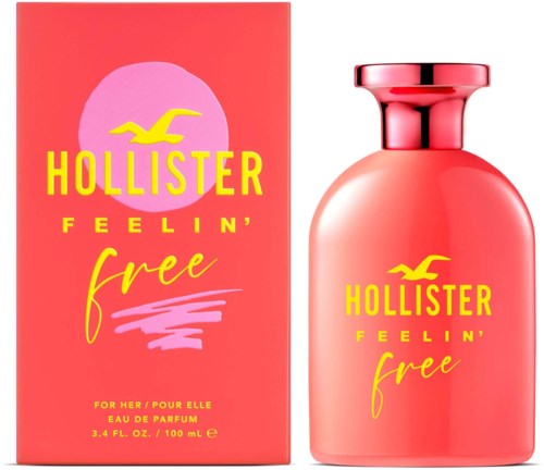 Een roze parfumfles en doos met gele tekst en vogel logo, gelabeld Hollister Feelin' Free.