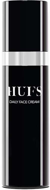 Ein schwarzer und silberner Behälter mit den Worten "HUES DAILY FACE CREAM".