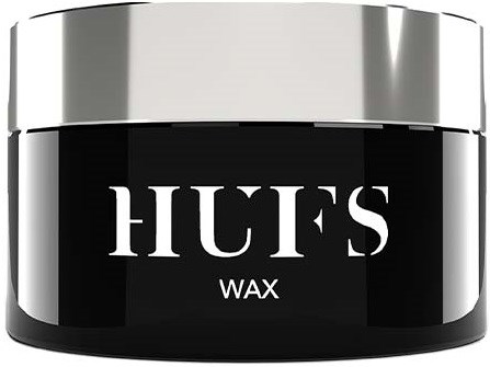 Ein schwarzer Behälter mit silberner Deckel, gekennzeichnet "HUF'S WAX" für Haarwachs.