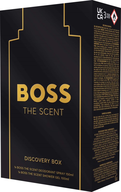 Black box with gold text and lines, labeled BOSS THE SCENT, Discovery Box, with details about its contents.