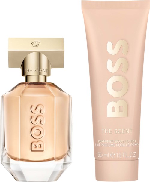 A BOSS perfume bottle with a gold cap and a matching pink body lotion tube with BOSS logo, both in soft pastel shades.