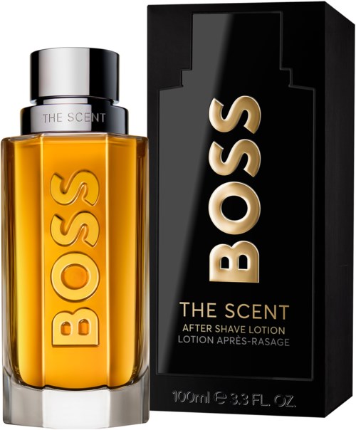 Een BOSS aftershave lotion fles en doos, beide zwart en goud, met grote BOSS-logo en productinformatie.