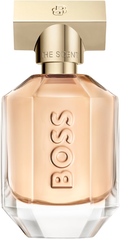 Een BOSS parfumfles met een gouden dop, doorzichtig glas en lichtroze parfum binnen.