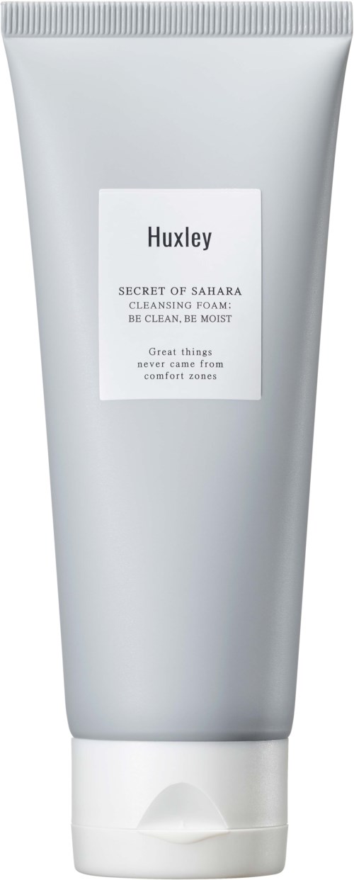 Een zilverkleurige tube met een wit label waarop staat "Huxley, Secret of Sahara, Cleansing Foam, Be Clean, Be Moist."