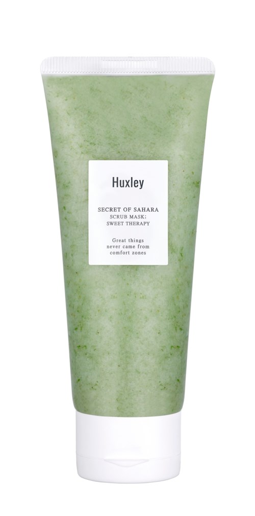 Groene tube met Huxley scrubmasker met witte label. Tekst op label noemt "Secret of Samara" en "Great things come from confident skin."