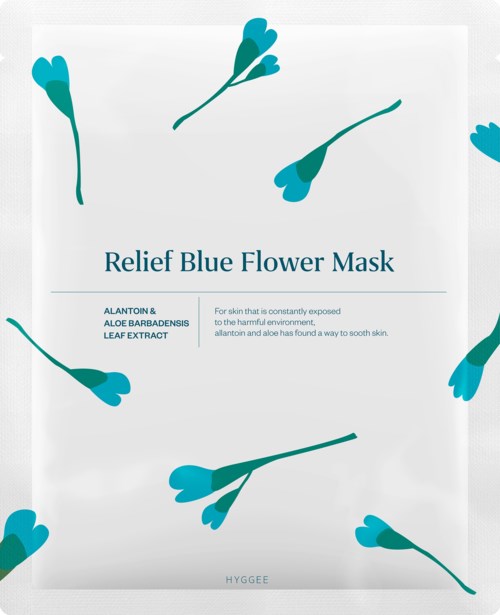 A package for a blue flower face mask features blue flower illustrations and text promoting skin soothing benefits.