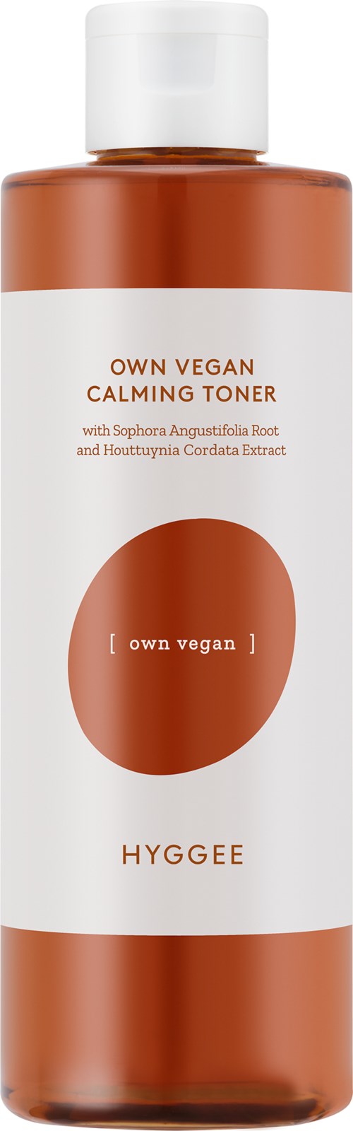 A brown and white bottle labeled 'Own Vegan Calming Toner' with text about ingredients and brand 'Hyggee'.