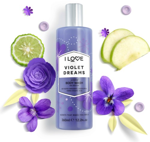 A violet body wash bottle surrounded by purple flowers, lemon slices, and violet-colored beads and slices.