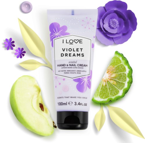A violet hand and nail cream tube surrounded by a violet flower, green lime, apple slice, and yellow leaves.