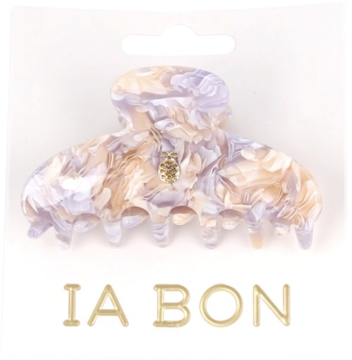 A marbled hair clip with a small golden pineapple charm and the words "IA BON" in gold letters.