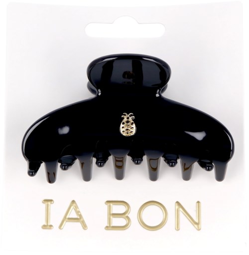 A black hair clip with a small decorative ladybug on it, displayed on a card with the words "IA BON".