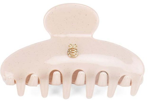 A beige hair claw clip with a small decorative gold pineapple in the center.