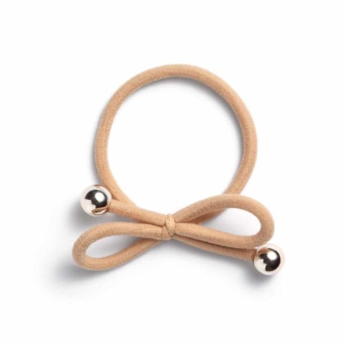 A beige hair tie with a bow and silver ball ends. Simple and cute accessory.