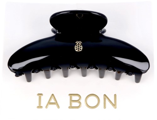 A black hair clip with a small bee charm and the words 'LA BON' in gold underneath.