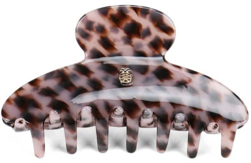 A leopard print hair clip with a small decorative gold piece in the center.