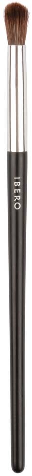 A small makeup brush with a black handle and brown bristles, standing upright on a black background.