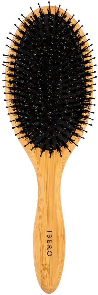 A wooden hairbrush with black bristles arranged in a rounded shape.