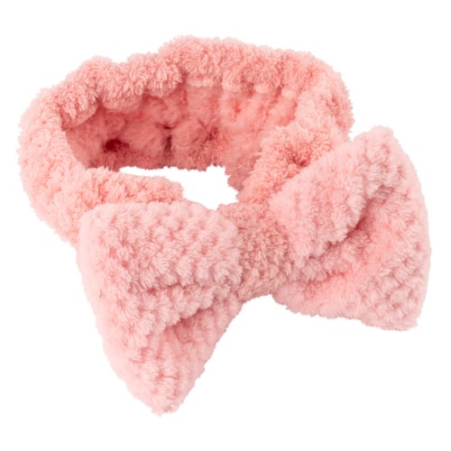 A pink fluffy fabric item, shaped like a bow or a scarf, soft and cozy looking.