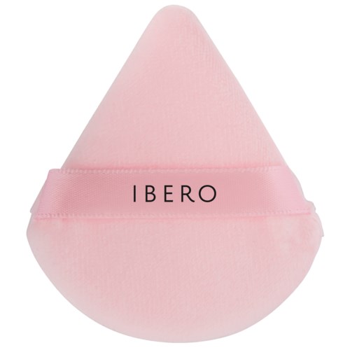 A pink teardrop-shaped makeup sponge with the word 'IBERO' printed on it.