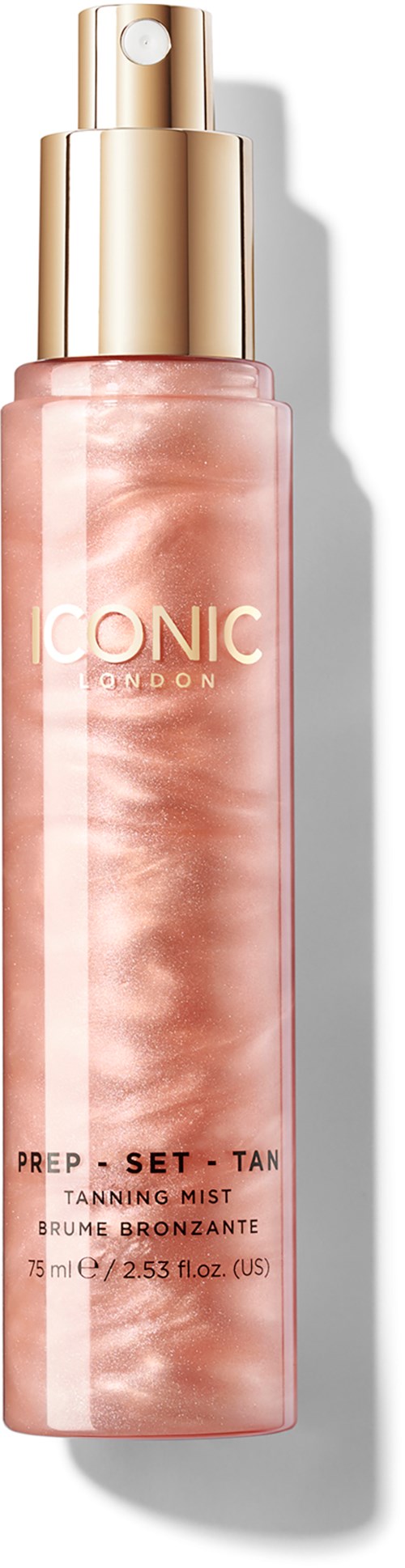 A spray bottle with a gold cap and pink marbled body, labeled ICONIC London PREP - SET - TAN TANNING MIST.