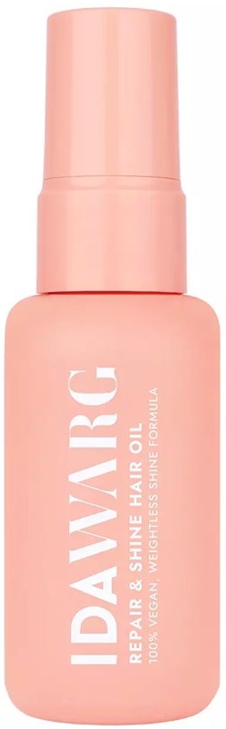 Roze fles met haarolie met Spraydop, labelt 'IDAVARKG Repair & Shine Hair Oil'.
