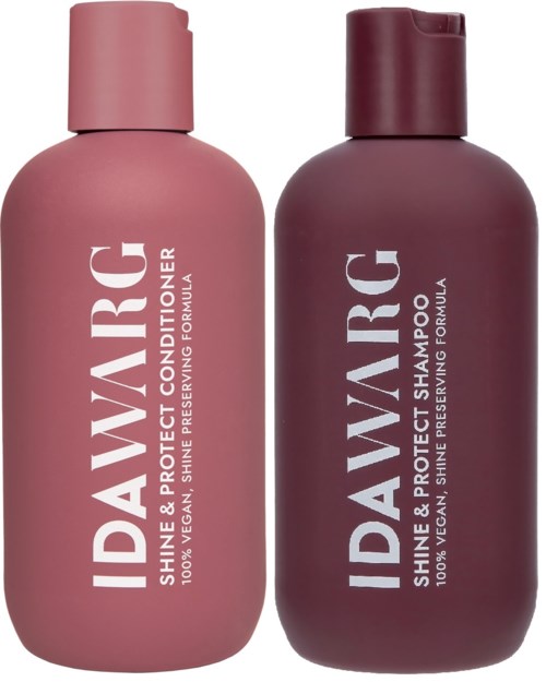 Two bottles of David's shine and protect hair products, one pink conditioner and one dark purple shampoo.