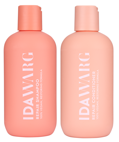 Zwei rosa Flaschen mit Haarpflegeprodukten, etiketti Shampoo und Conditioner, mit runden Kappen und weißem Text.