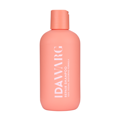 A pink bottle labeled "IDAVARG" with white text, indicating a repair and nourishing shampoo.