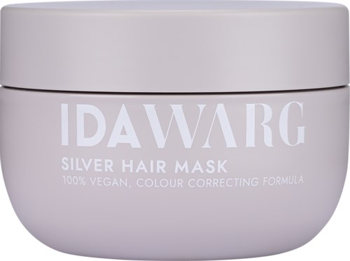Een witte container met label IDA WARG en zilveren haarmasker, vermeldt dat het vegan en kleurcorrigerend is.