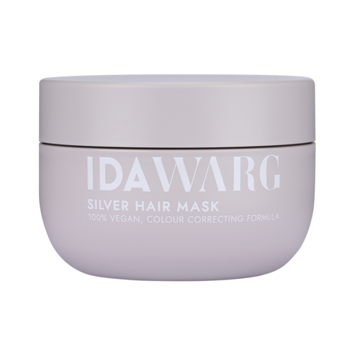Een witte pot met label 'IDAWARG SILVER HAIR MASK' en beschrijving van veganistische en kleurcorrigerende formule.