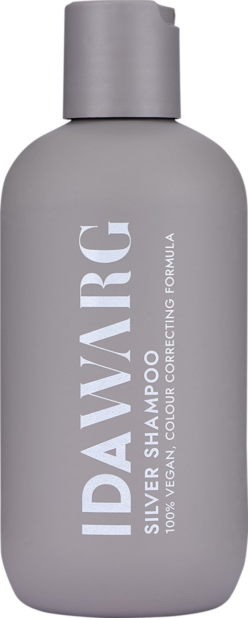 Eine graue Shampoo-Flasche mit weißem Text, mit der Aufschrift 'IDAVARGIC Silver Shampoo' für Farbkorrektur, vegan und sulfatfrei.