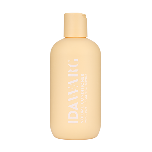 A beige bottle labeled 'IDALYBARG' with text about volume and conditioning, likely a hair care product.