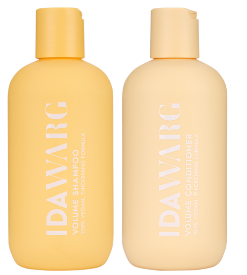 Two bottles of hair care products, one shampoo and one conditioner, in yellow and cream colors.