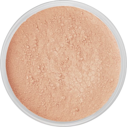 A round container filled with peach-colored powder that has a slightly rough and uneven surface.