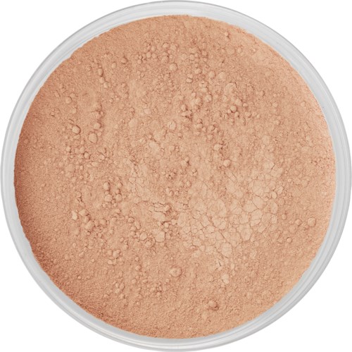 A round container of beige or tan loose powder, with some clumps and a slightly textured surface.