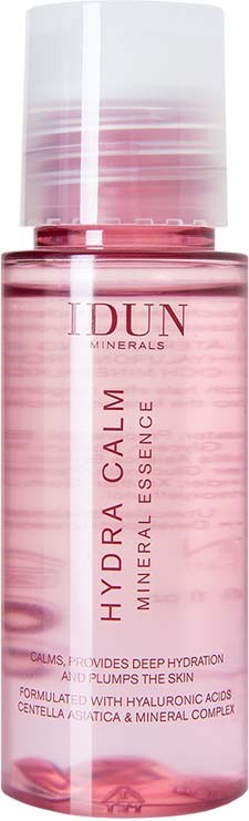 A pink bottle with a white cap, labeled 'HYDRA CALM'. It is a mineral essence for calming and hydrating skin.