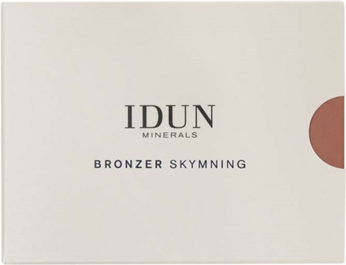 Das Bild zeigt eine Schachtel von IDUN Minerals Bronzer Skymning mit einem minimalistischen weißen Design und einem kleinen braunen Kreis.