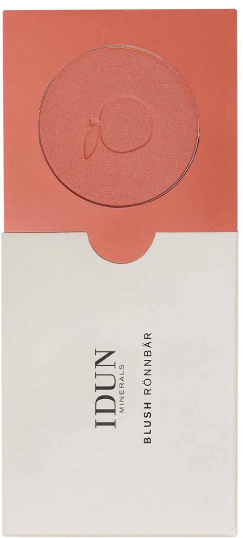 A blush with a round shape and a small logo on top. The packaging is pink and white with text.