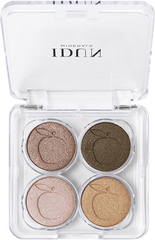 A clear plastic case with four circular eyeshadow pans in peach, dark green, light pink, and gold shades.
