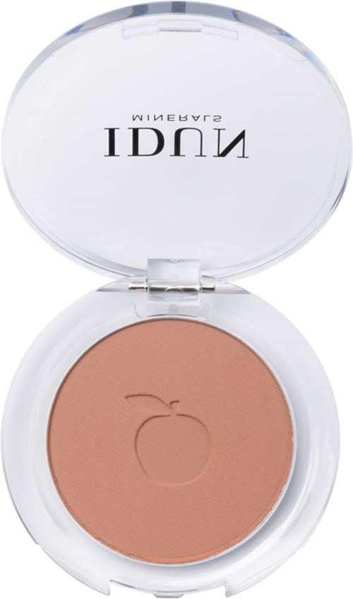 A compact with peach-colored blush and a small apple logo on it, under a clear lid.