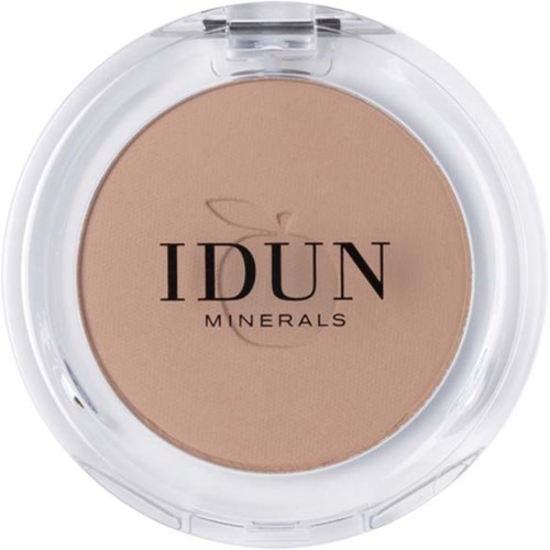 A compact of IDUN Minerals pressed powder, light beige color, clear plastic cover, brand name in black text.