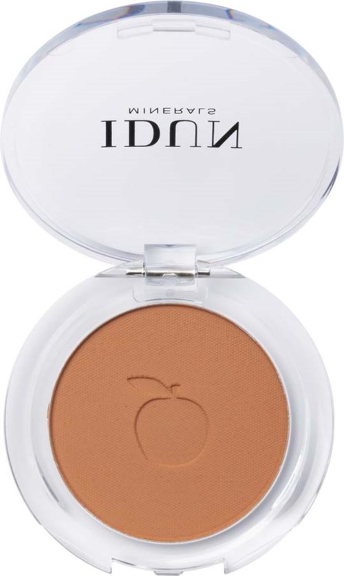 A compact with beige makeup, featuring an apple logo and clear lid. The brand name is visible when opened.