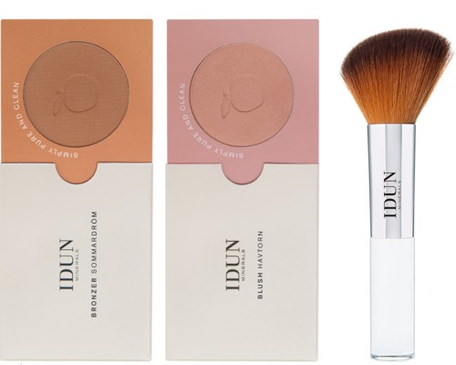 Two blush palettes and a makeup brush. The palettes are in square boxes with open lids showing blush. The brush is beside them.