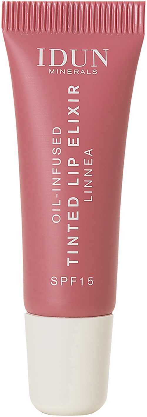 A pink tube of IDUN Minerals lip balm with SPF 15, named Finte Lip Elixir, poses upright in the image.