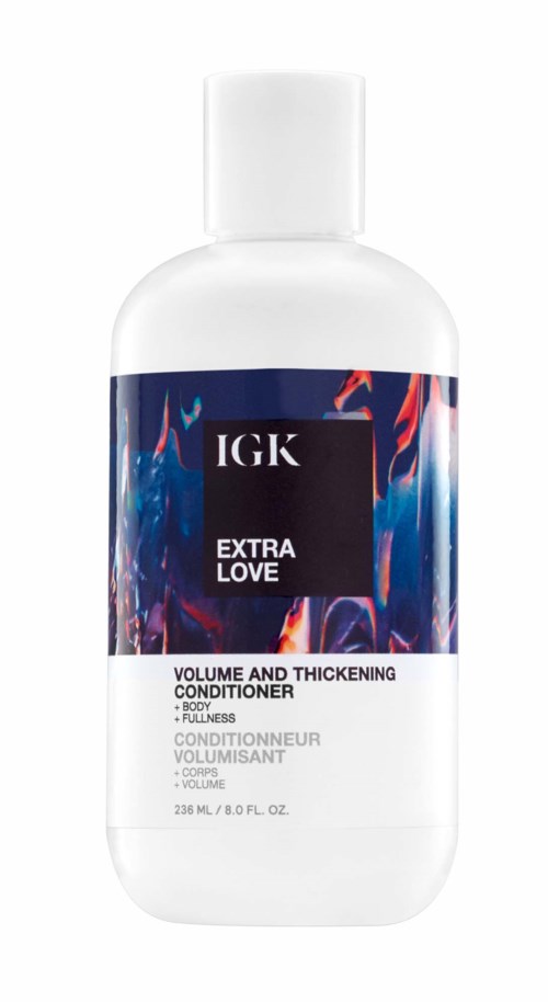 Eine weiße Flasche mit buntem Etikett für IGK Extra Love Conditioner, für Volumen und Verdickung.